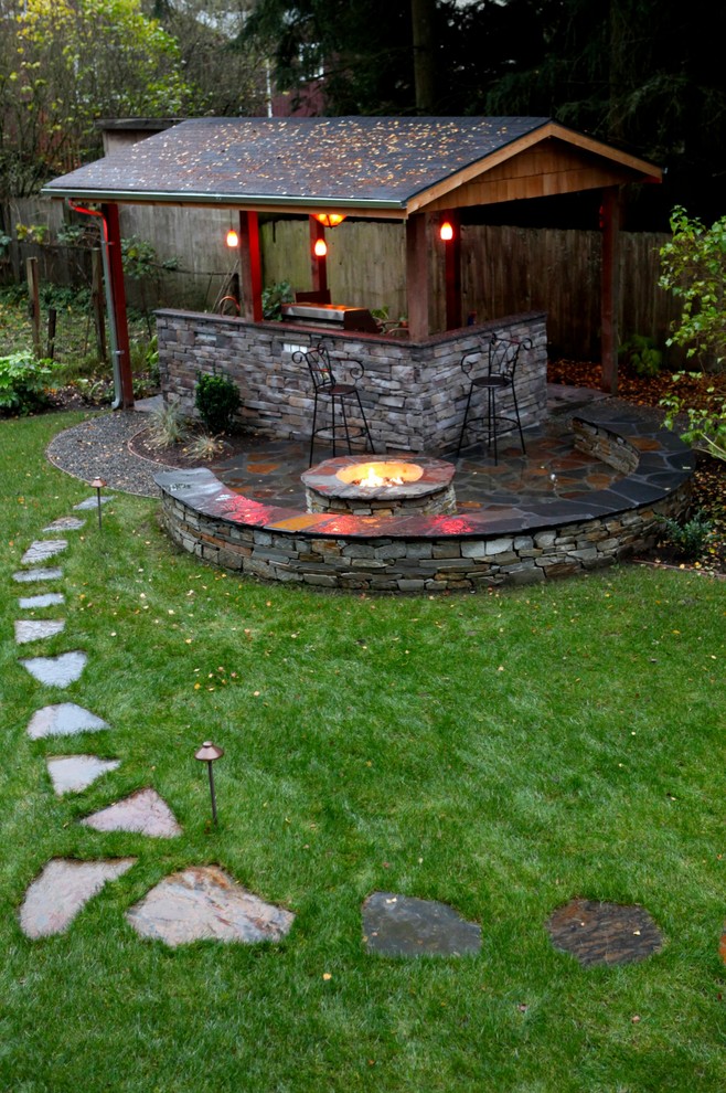 A fire bowl right next to the outdoor cooking zone would make an entertaining there more cozy.