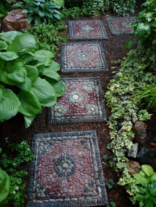 a bright and catchy pebble pathway with tiles covered with burgundy, black and grey pebbles on top