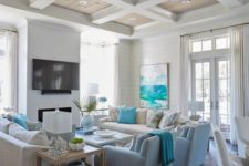 a bright beach living room with turquoise touches, light blues, creamy and white items