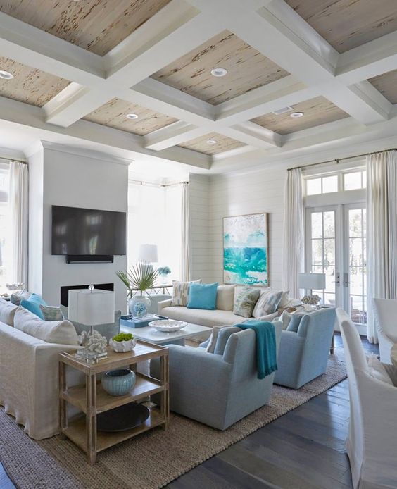 a bright beach living room with turquoise touches, light blues, creamy and white items