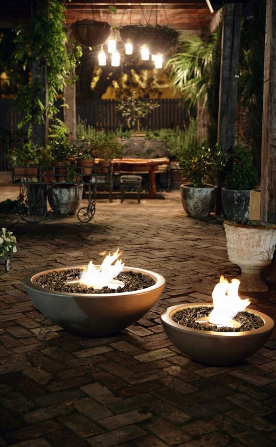 a duo of matching fire bowls with ethanol is a lovely way to illuminate and make your space more welcoming