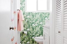 a fun and playful tropical bathroom with an accent wall, a pink and flamingo rug, a flamingo curtain and pink towels