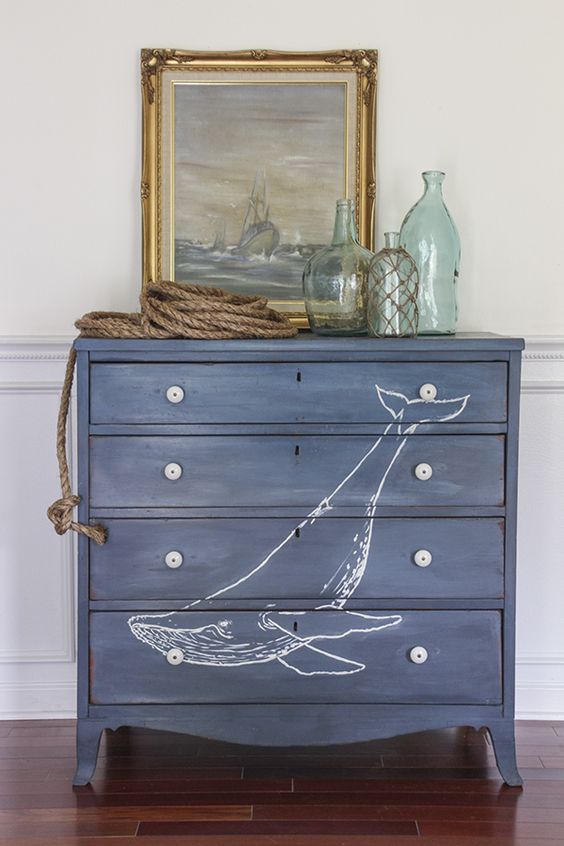a navy dresser with a whale is a lovely idea for a nautical or coastal space, it will add color and interest
