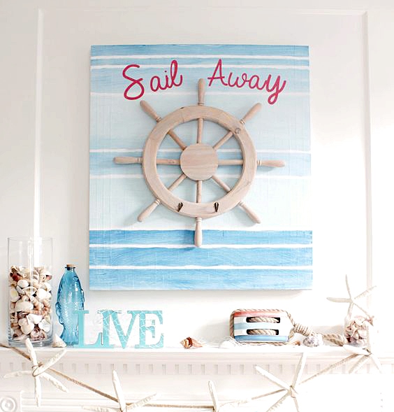 a simple beachy mantel with a bright seaside artwork, a blue fish-shaped bottle, jars with seashells and a starfish garland