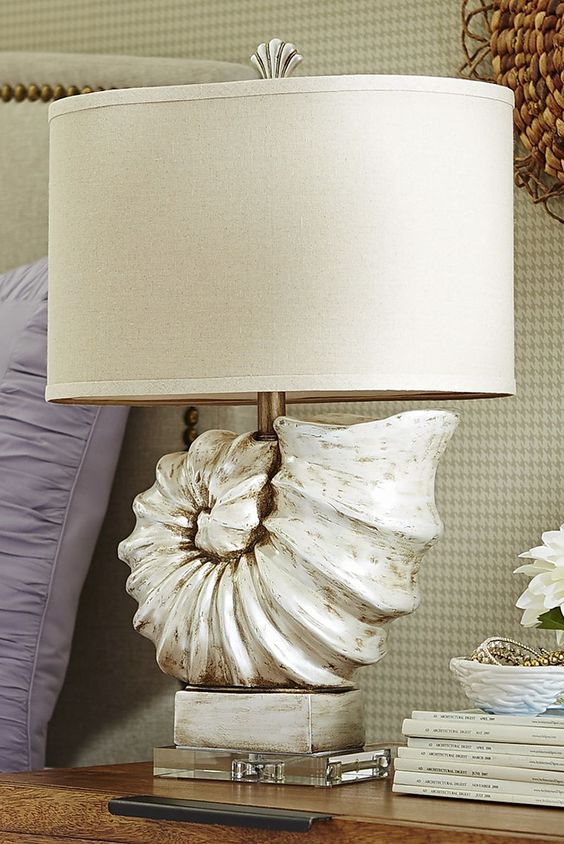 a statement table lamp featuring an oversized seashell and a plain lampshade is a gorgeous idea for any beachy space