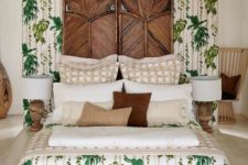 a whimsical tropical bedroom with carved wooden screens, touches of wood and rattan, tropical bedding and wooden lamps