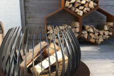 an eye-catchy modern fire bowl on a metal stand will let you enjoy all the flames while it’s on fire