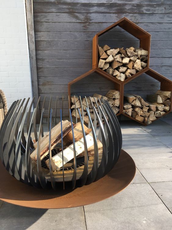 an eye-catchy modern fire bowl on a metal stand will let you enjoy all the flames while it's on fire