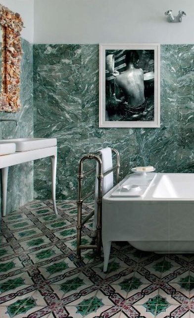 green marble tiles on the walls and mosaic tiles on the floor for a bold eclectic look