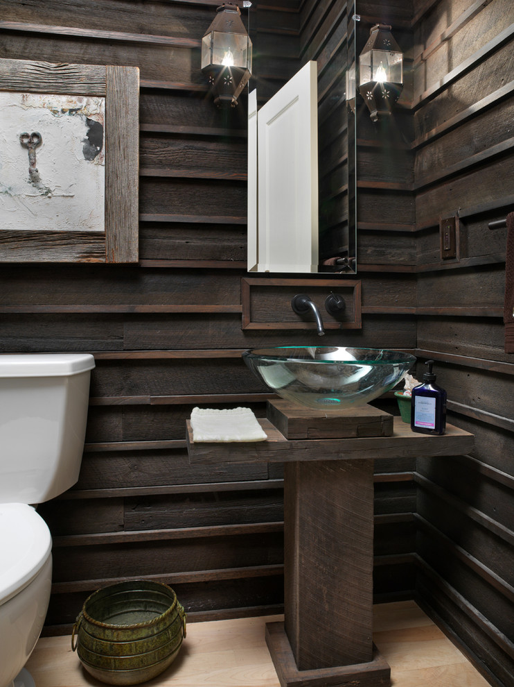 a contemporary meets rustic bathroom with dark stained wood, a glass sink, some wall lamps (Melaragno Design Company, LLC)