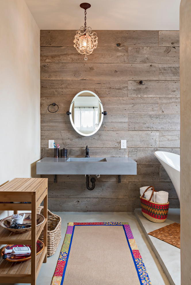a contemporary rustic bathroom with a wooden wall and furniture and touches of concrete (Dane Cronin Photography)