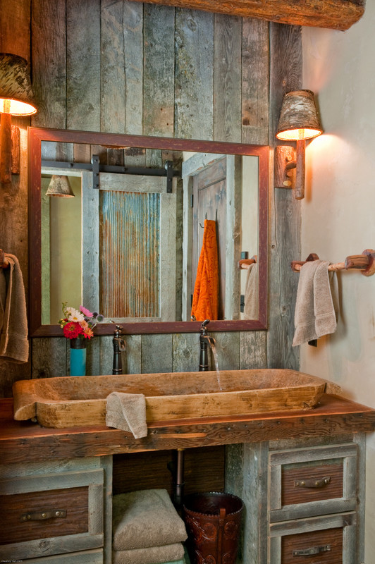 a rustic meets vintage bathroom with weathered wood and stone touches (Highline Partners, Ltd)