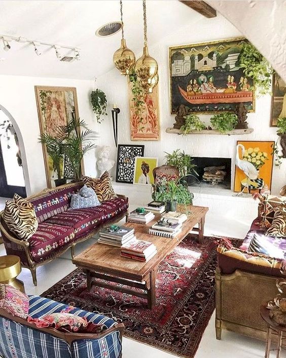 a chic Moroccan inspired living room with plants, printed and patterned textiles and rugs and lamps