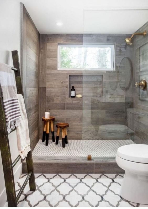 a contemporary meets rustic bathroom with tiles that imitate weathered wood