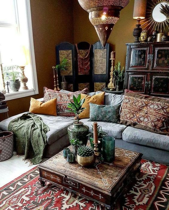 a modern Moroccan living room with Moroccan lamps, a patterned coffee table and pillows and rugs