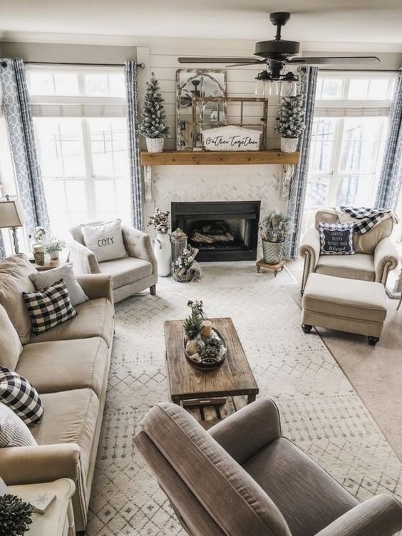 a neutral rustic living space with a woode table and mantel, some touches of buffalo check and flocked mini Christmas trees