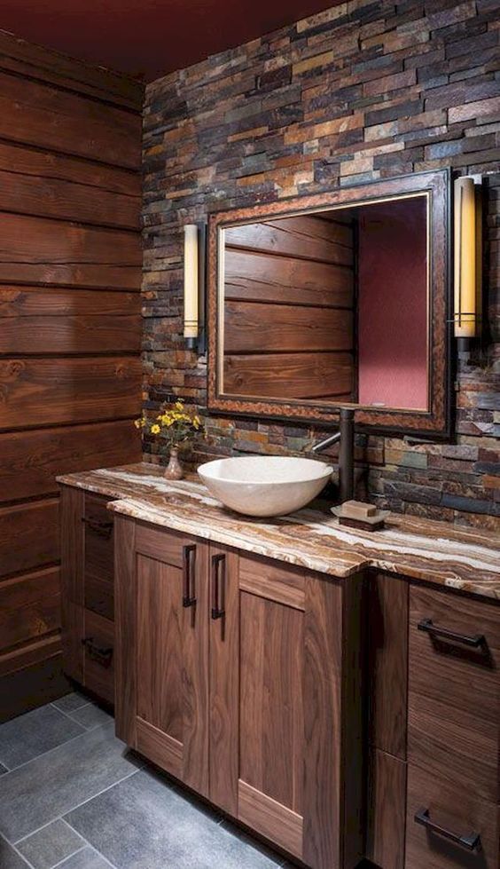 a rustic meets modern bathroom with much wood and fake stone for a cozy feel