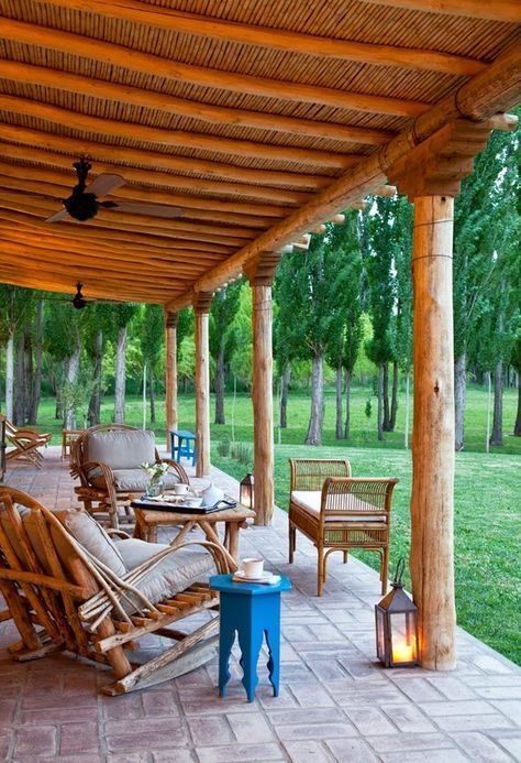 a simple rustic patio with rattan and wooden furniture, stained and painted and candle lanterns