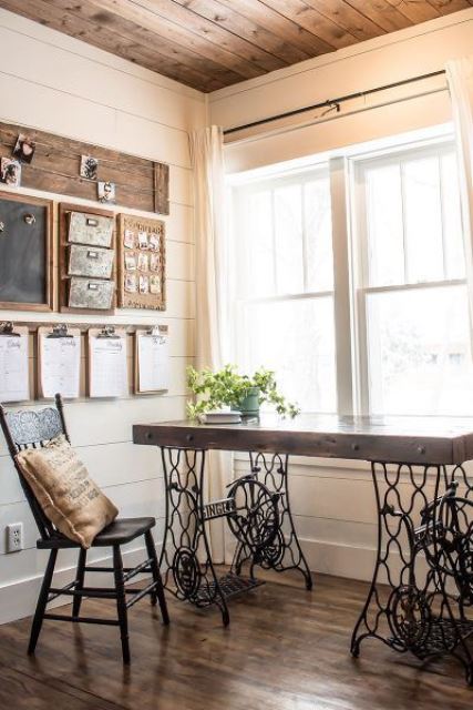 a vintage rustic home office with a chic desk, a wooden chair, a wooden board and a chalkboard is very cozy