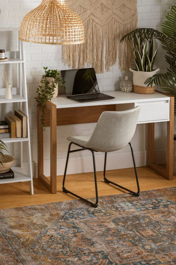 a boho chic home office with a desk, a comfy leather chair, a macrame hanging, a rattan lamp and potted plants