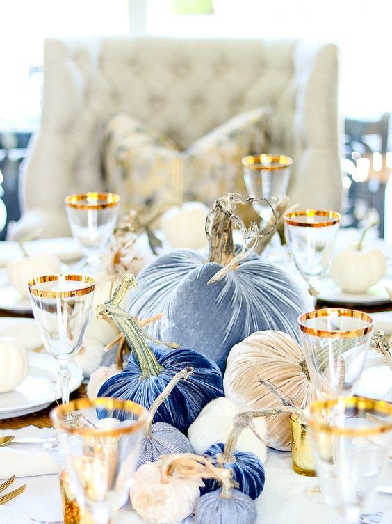 a bright fall centerpiece of blue, neutral and navy velvet pumpkins is super bold and glam