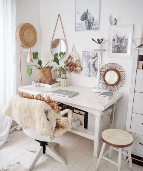 a cozy boho home office nook with a monochromatic gallery wall, mirrors, faux fur, fringe and baskets