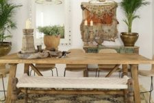 a free-spirited dining room with catchy pendant lamps, carved wooden furniture and a macrame bench