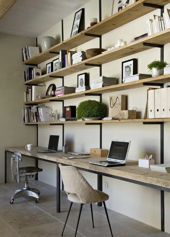 a modern rustic home office with a large open shelving unit and a desk attached under them, some chairs and accessories and decor