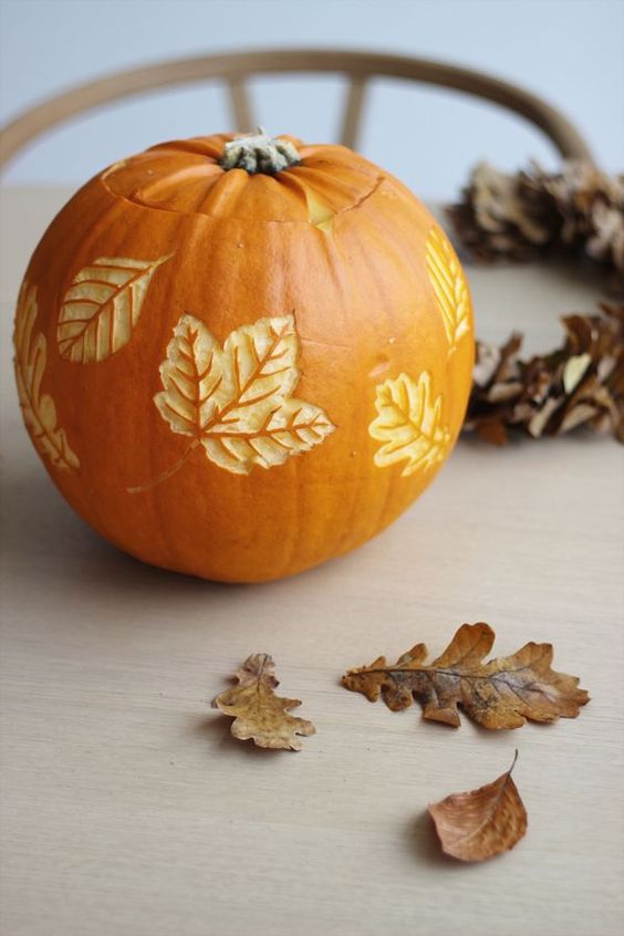 a pumpkin with carved leaves is a beautiful all-natural fall decoration you can make yourself