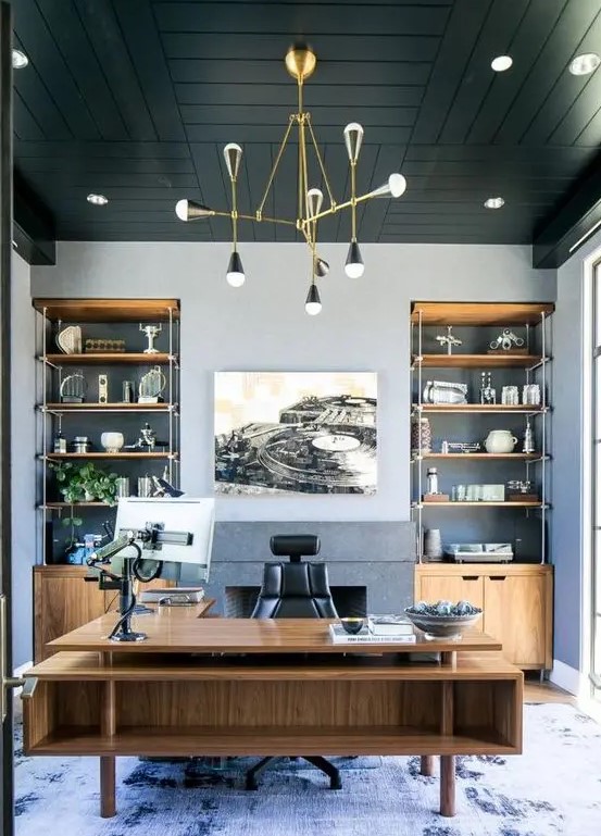 مكاتب منزلية A-refined-beach-home-office-with-grey-walls-a-black-wooden-ceiling-built-in-storage-units-and-a-large-stained-desk-plus-a-sea-inspired-rug