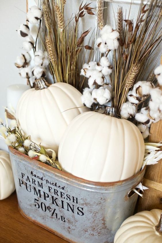a rustic fall arrangement of pumpkins, cotton and wheat bundles in a metal bathtub is a lovely idea for the fall