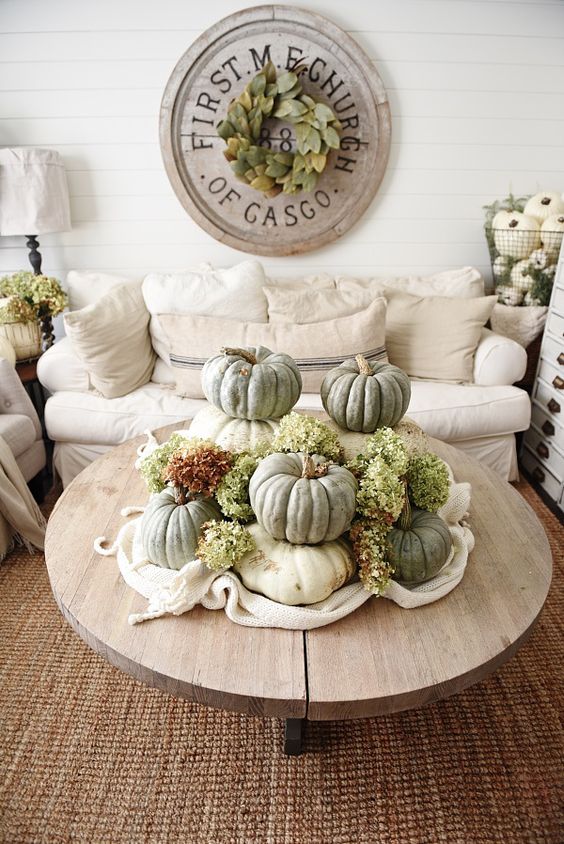 a rustic fall decoration of stacked heirloom pumpkins and green hydrangeas is a lovely centerpiece or just decoration