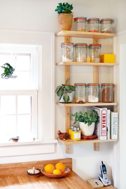 a small open shelf taking an awkward nook will let you store a lot of stuff without grabbing precious cabinet space