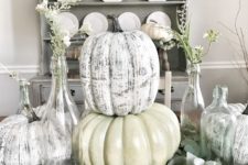 a vintage centerpiece of greenery, faux whitewashed pumpkins and some blooms in bottles for the fall