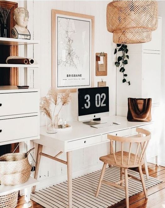 an airy boho home office with a sleek desk, a wooden chair, a rattan lamp and an open-closed storage unit, pampas grass for decor