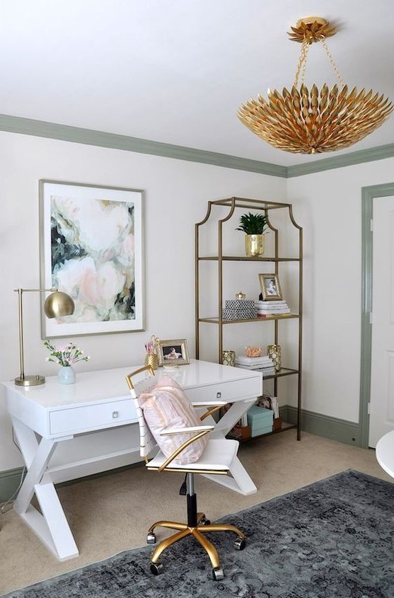 an elegant feminine home office with a white desk, an open storage unit, a gold chandelier and a small chair