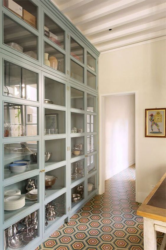 an oversized glass fronted cabinet with many compartments is great for storing your tableware and other stuff