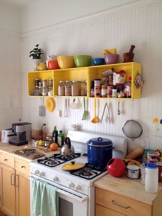 bright yellow crates attached to the wall for storage form a simple open storage unit