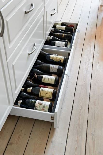 large flat drawers in the lower part of the kitchen island are great for storing wine and other drinks that don't require fridges