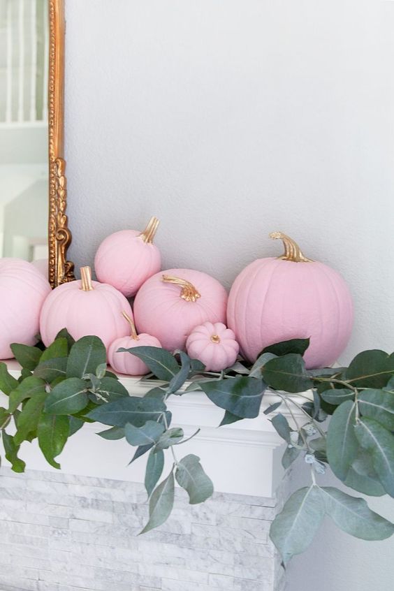 light pink pumpkins with gilded stems and lots of greenery will make the mantel look super glam and fall-like