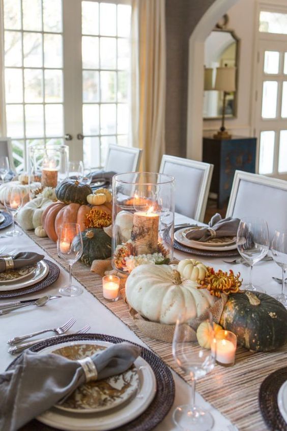 natural fall table decor with candles, pumpkins, blooms and tree stumps and branches is a cool idea for the fall