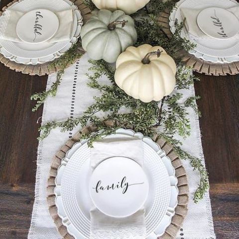 neutral pumpkins and greenery, wooden chargers and neutral tableware for a chic fall dinner
