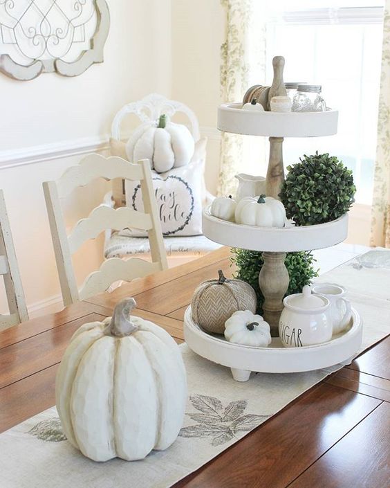 some fake neutral pumpkins, greenery balls and a printed runner will bring a slight fall feel to the space