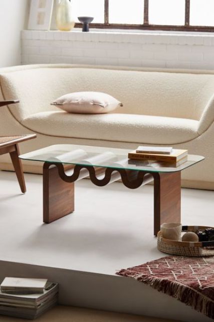 a catchy modern coffee table with a glass tabletop and a wooden table base is a stylish solution for a modern living room