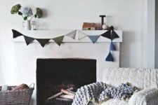 a chair with a white chunky knit cover, a chunky knit blanket and some pillows make the living room winter-inspired