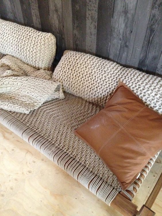 a cool woven bench with knit pillows and a matching blanket is a gorgeous place to have a nap