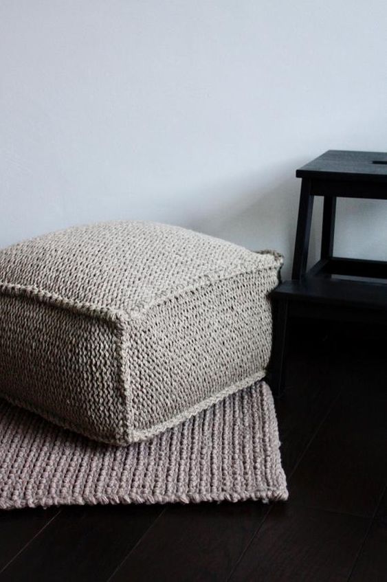 a cozy grey crocheted ottoman is a cool piece to make your space winter ready