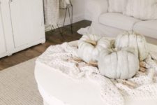 a crochet blanket and some large heirloom pumpkins on it are amazing for fall home decor