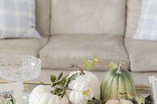 a fabric tray with natural pumpkins and white blooms for a neutral farmhouse coffee table