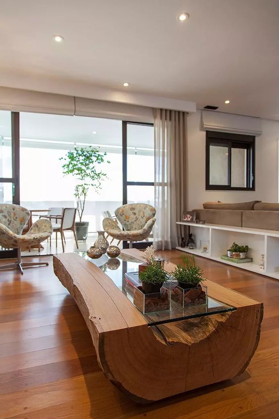 a fantastic modern coffee table of a wooden trunk with imperfections and a glass tabletop is a great idea for a rustic space